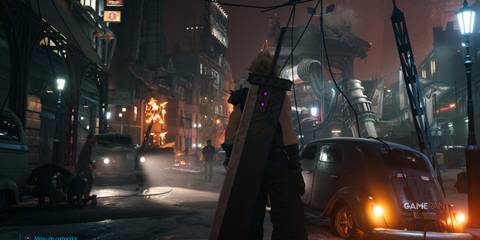 Cloud Strife in a chaotic street with burning cars and buildings in Midgar, Final Fantasy 7 Remake