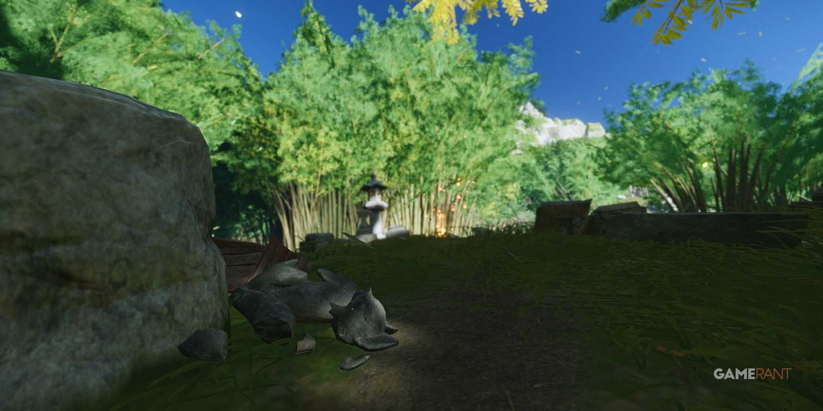 broken fox statue of an inari shrine with bamboo trees in the background