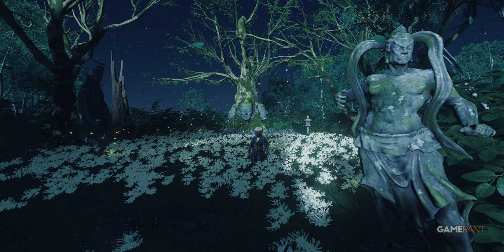 a statue at the entrance of a grove covered with white flowers under the night sky