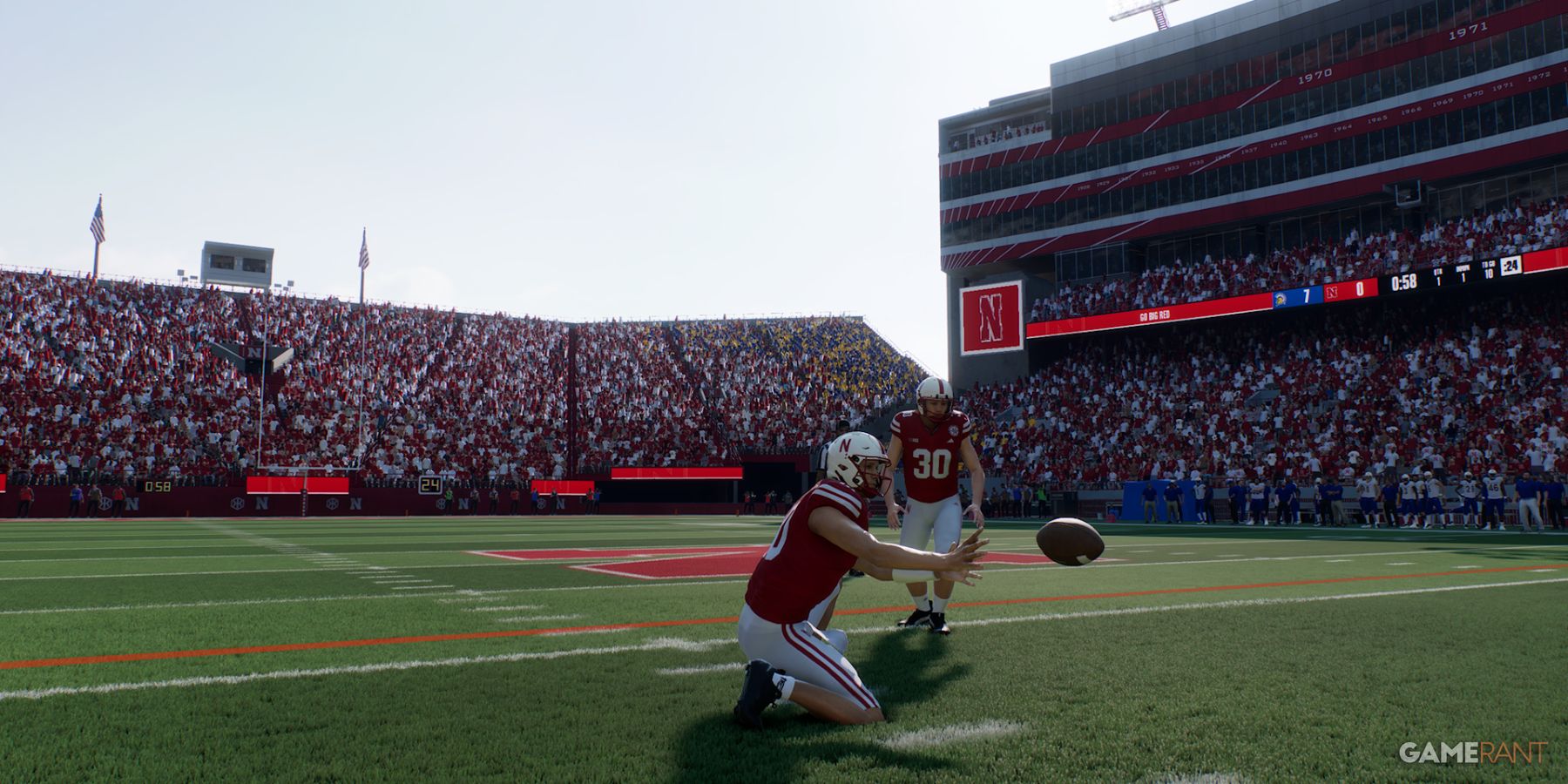 Nebraska players preparing for a play on the field in College Football 25