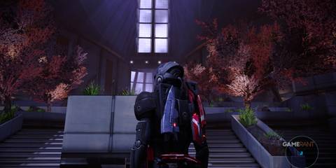 Shepard standing before steps with vibrant pink trees in The Citadel in Mass Effect 1