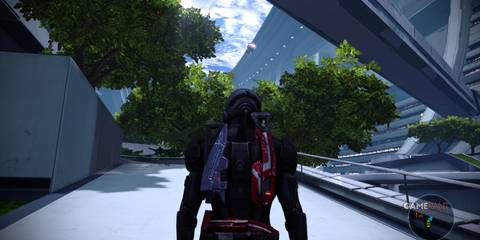 Shepard walking through a green, futuristic area in The Citadel in Mass Effect 1