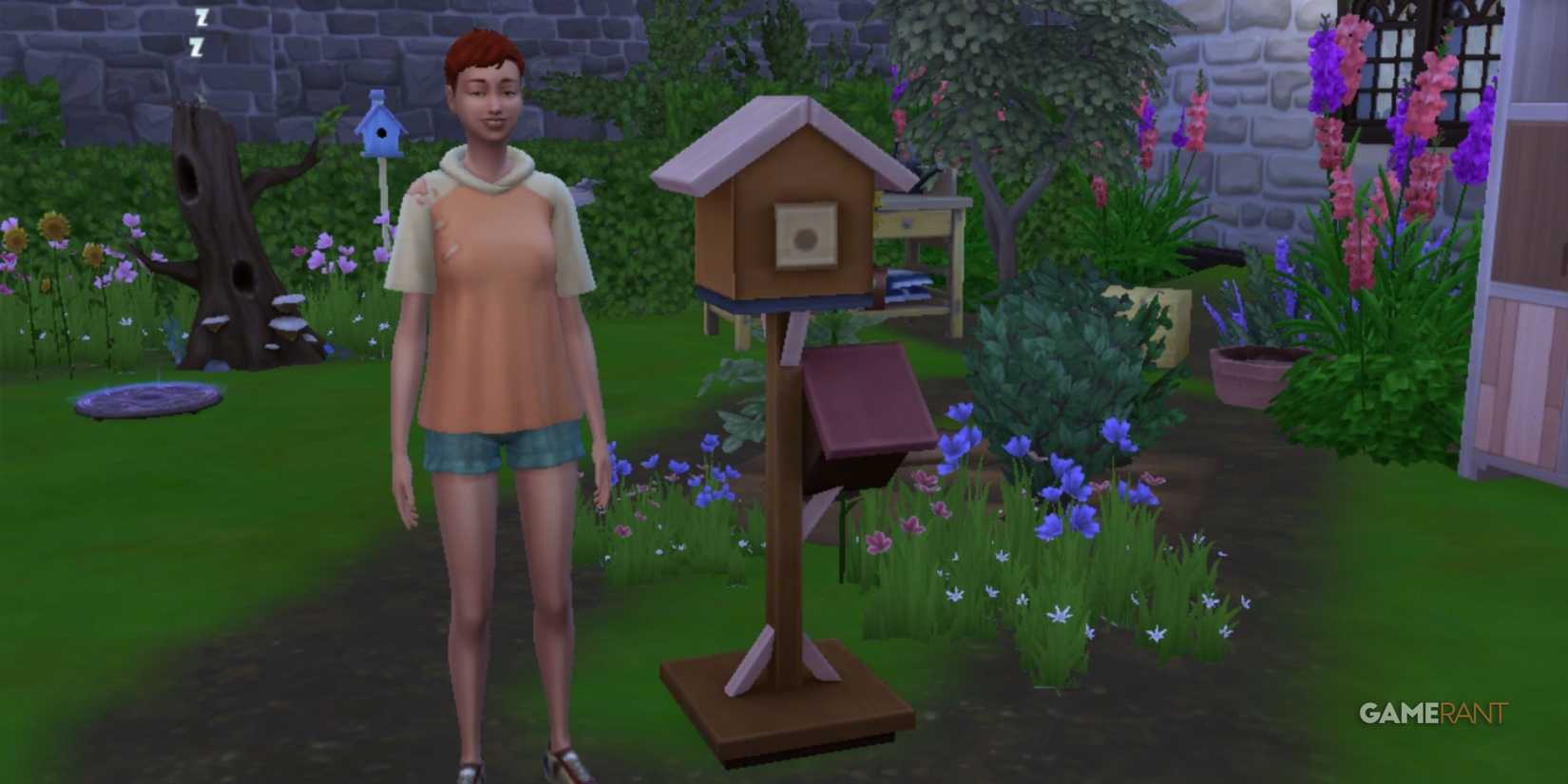 A sim with a pink shirt stands next to a little birdhouse from sims 4 eco lifestyle with flowers in the background