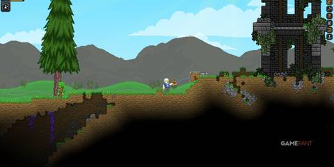 An Apex character standing near a crumbling ancient structure on a grassy planet in Starbound