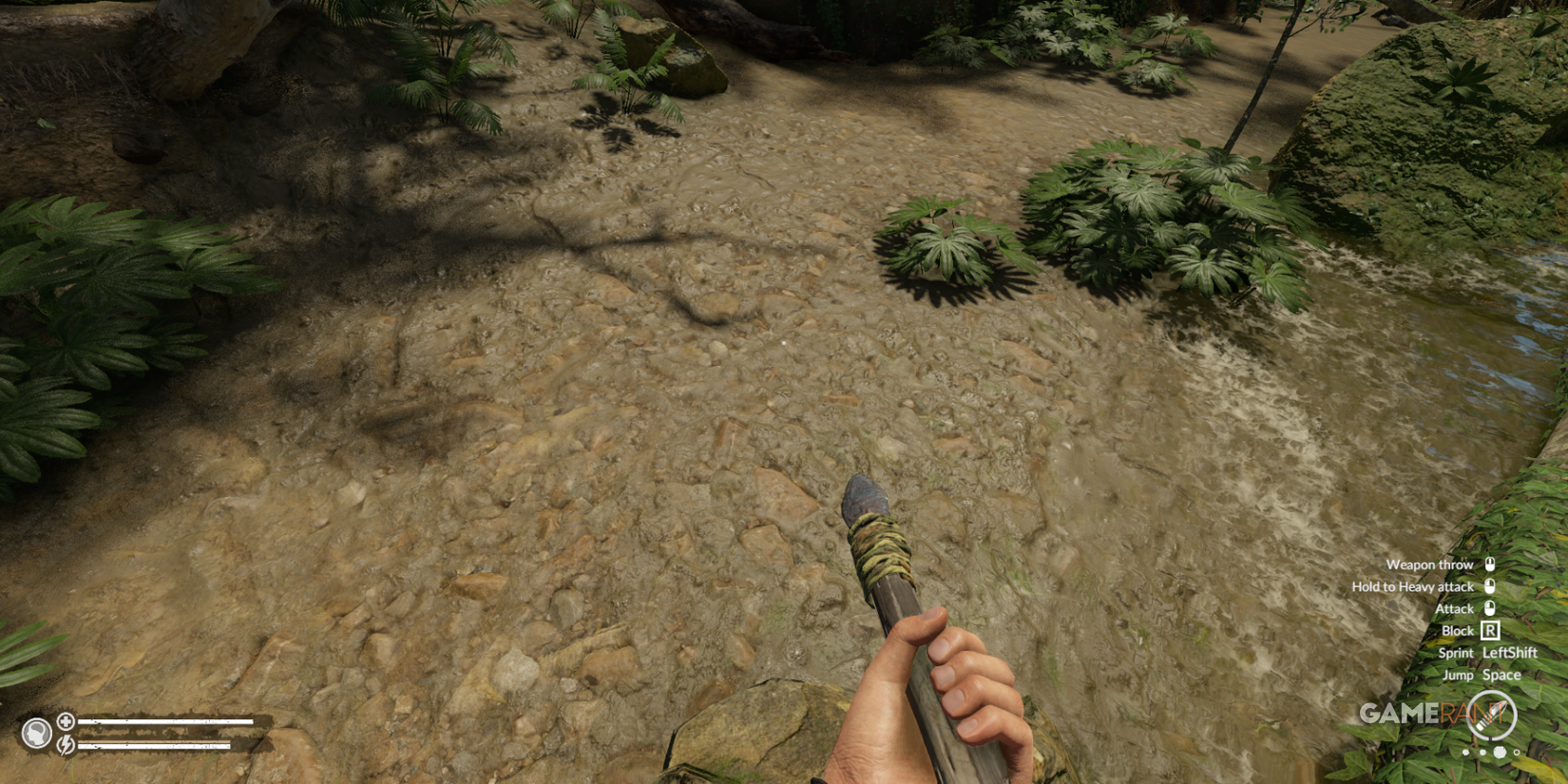 Walking along a rocky riverbed surrounded by dense jungle with a crafted spear in Green Hell