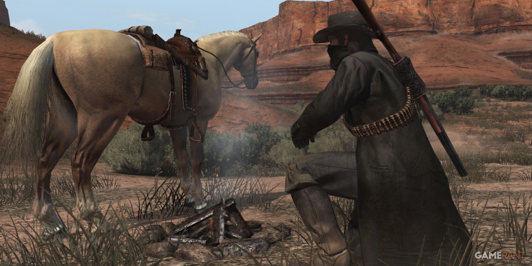 Character camping beside a horse in the desert landscape of Red Dead Redemption