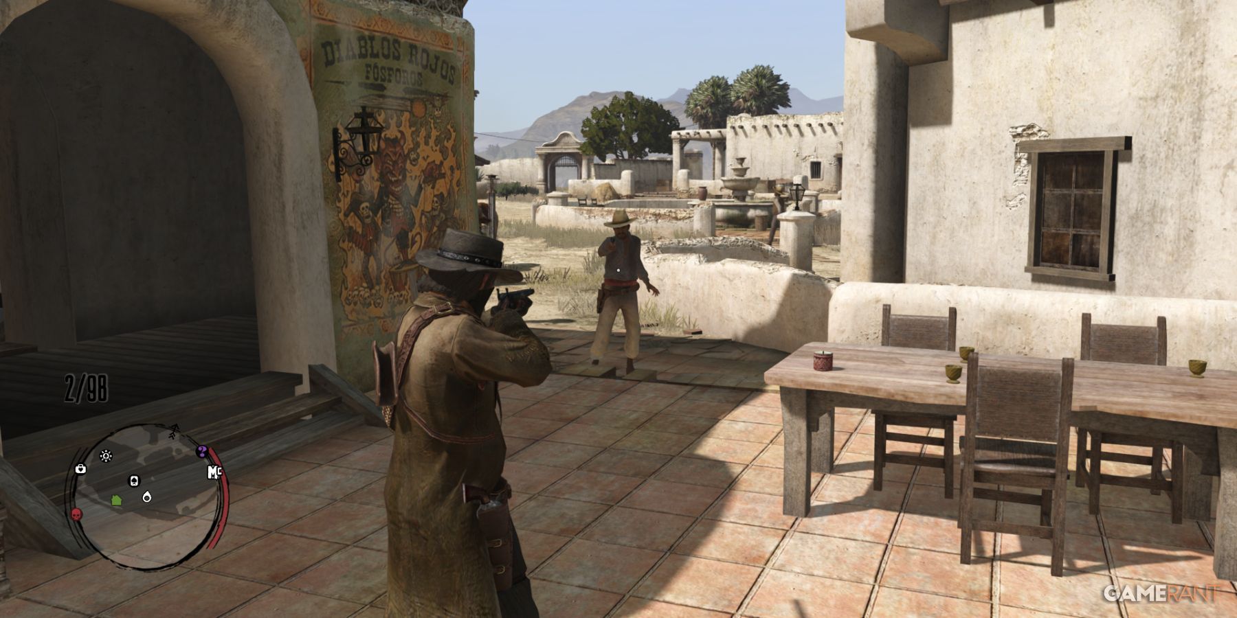 John Marston aiming at an enemy in a Mexican town square in Red Dead Redemption