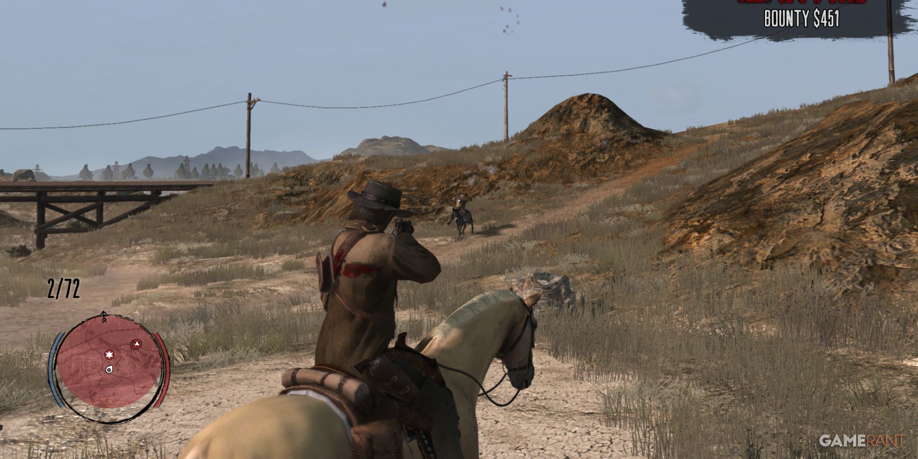 John Marston on horseback aiming at a distant foe in Red Dead Redemption, bounty on screen