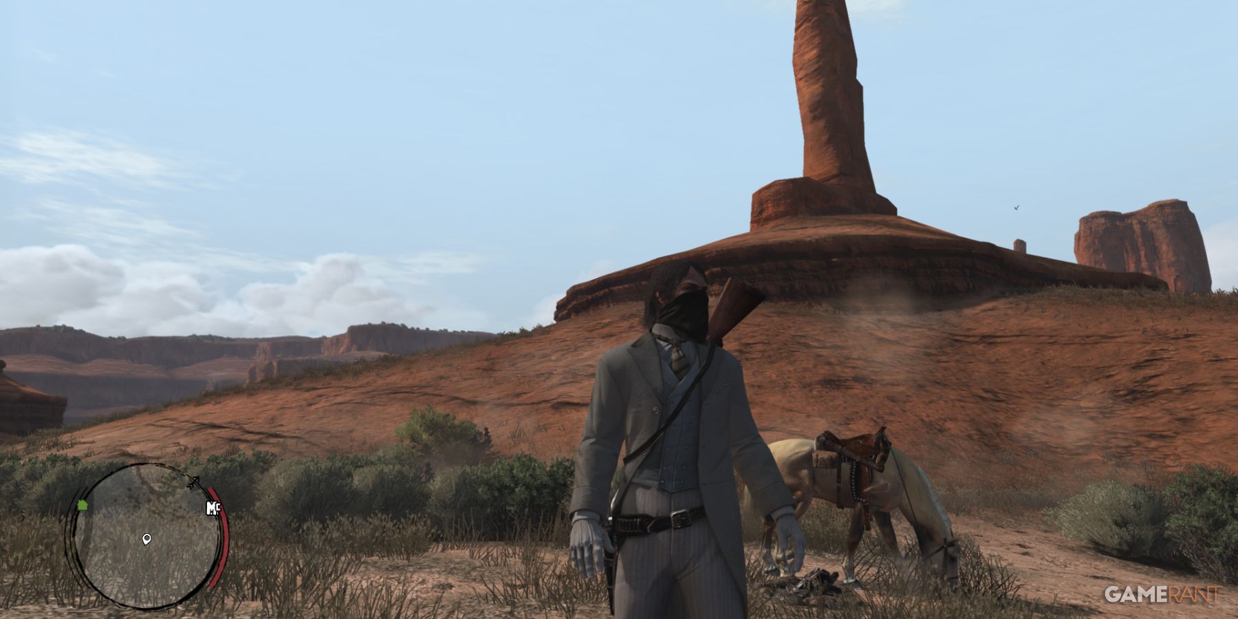 Masked character standing beside a horse in an open desert area in Red Dead Redemption