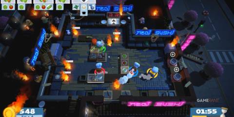 three chefs are working together in the video game Overcooked 2. Ovens are on fire and the kitchen is a mess. 