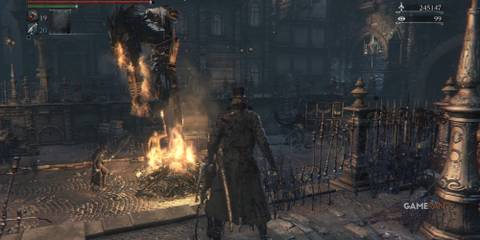 Player watches a bornfire with a burning beast and enemies standing watching