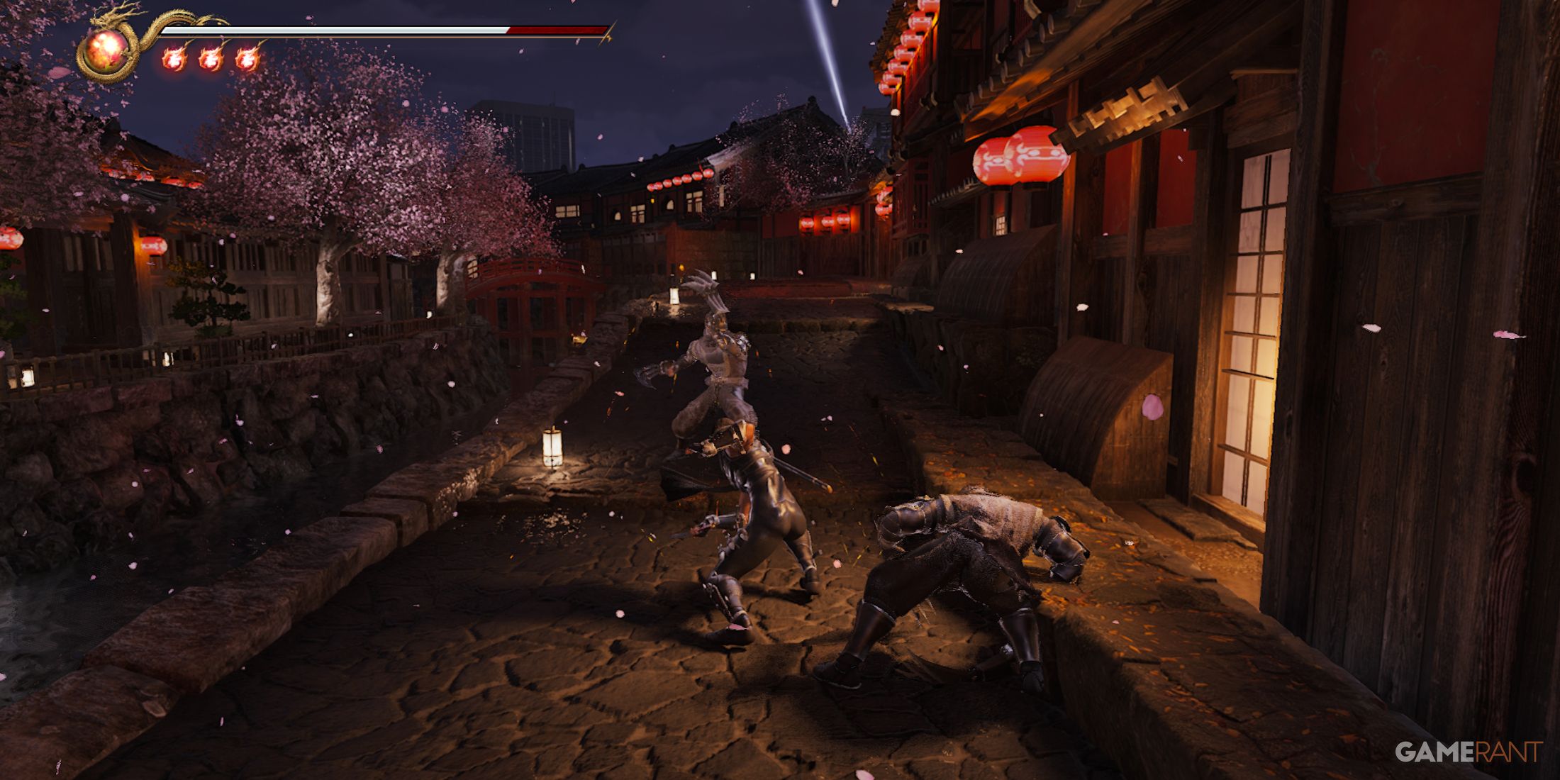 Fierce battle scene in Ninja Gaiden 2 Black set in a Japanese village at night with cherry blossoms