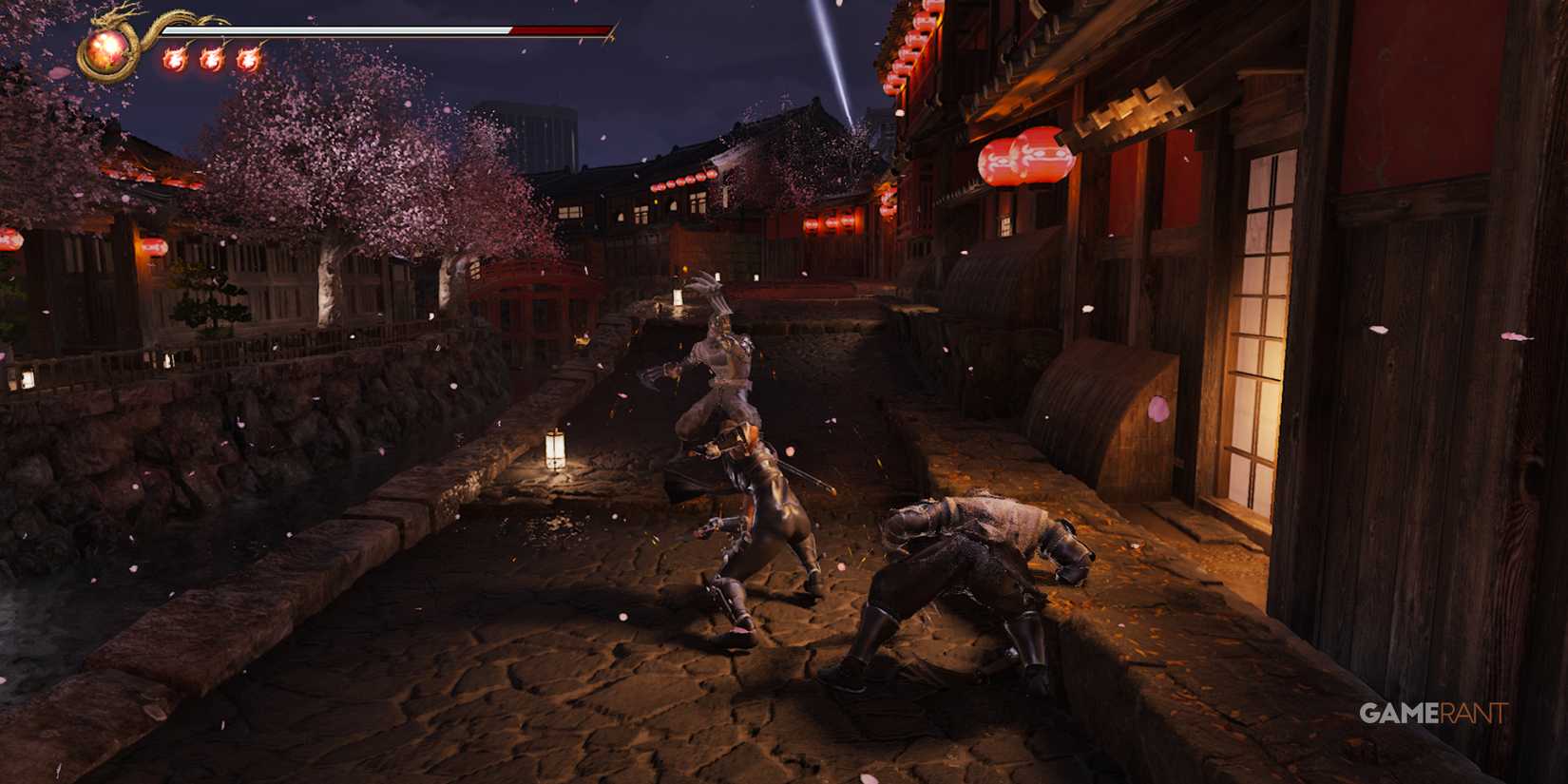 Fierce battle scene in Ninja Gaiden 2 Black set in a Japanese village at night with cherry blossoms