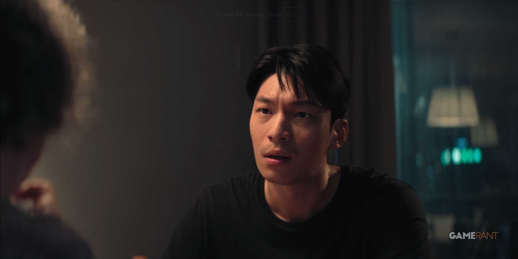 Jun-ho attempts to console his mother during a heated discussion in Squid Game.