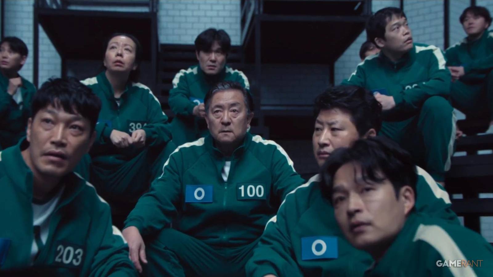 player 100 on squid game series surrounded with other players-3