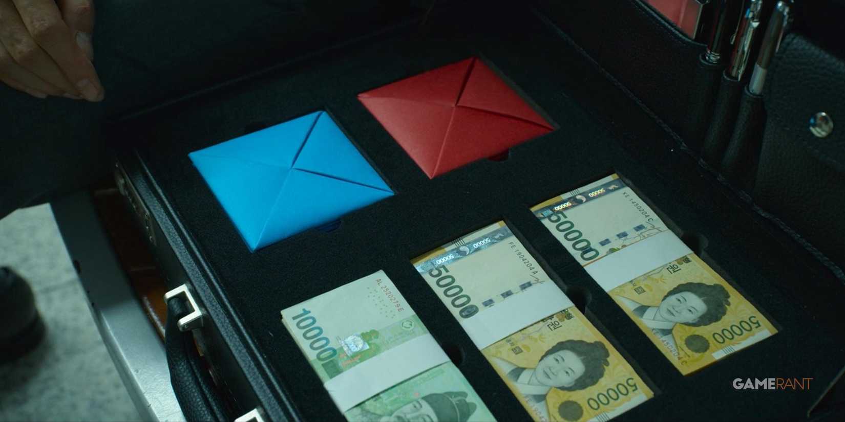 two card and money inside a metal case
