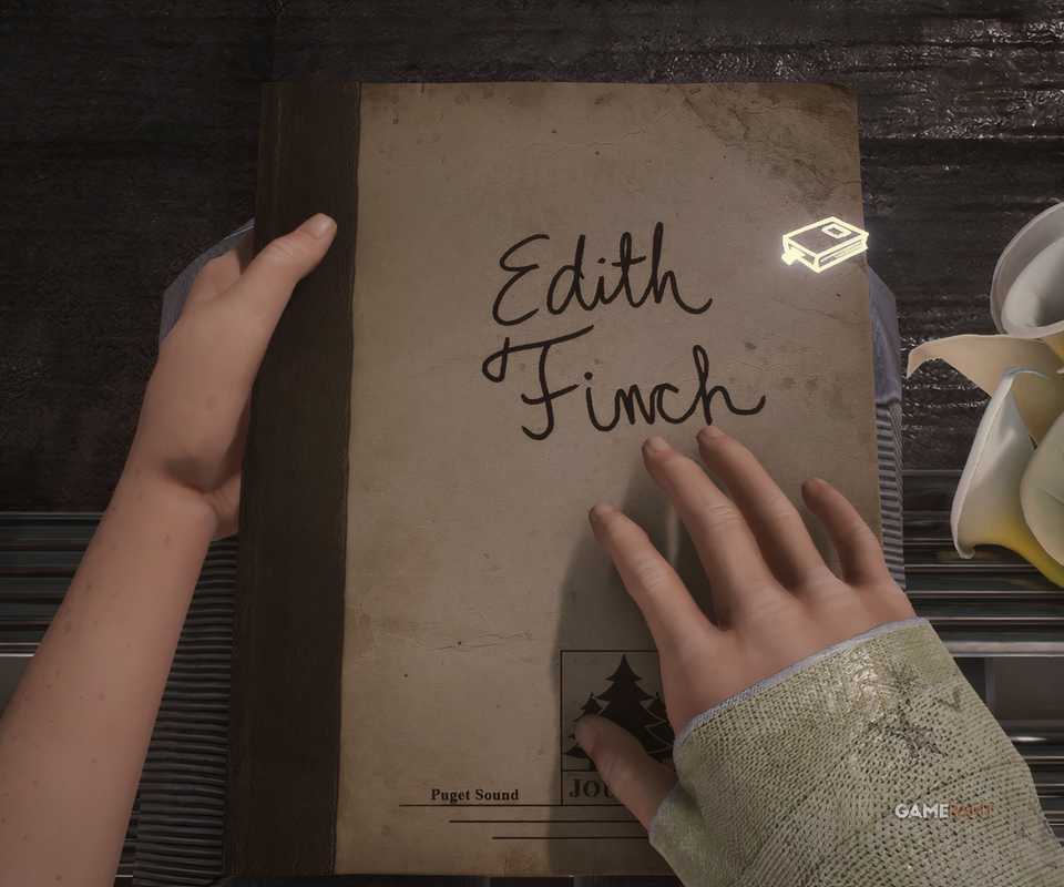 Edith memegang buku hariannya dalam game What Remains of Edith Finch