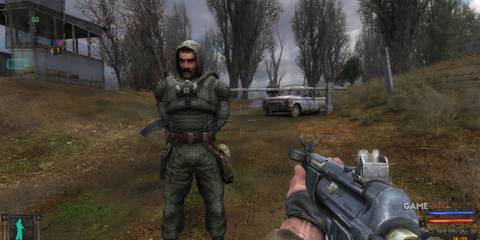8 Best Games Set in a Nuclear Wasteland, Ranked Holding a machine gun an NPC
