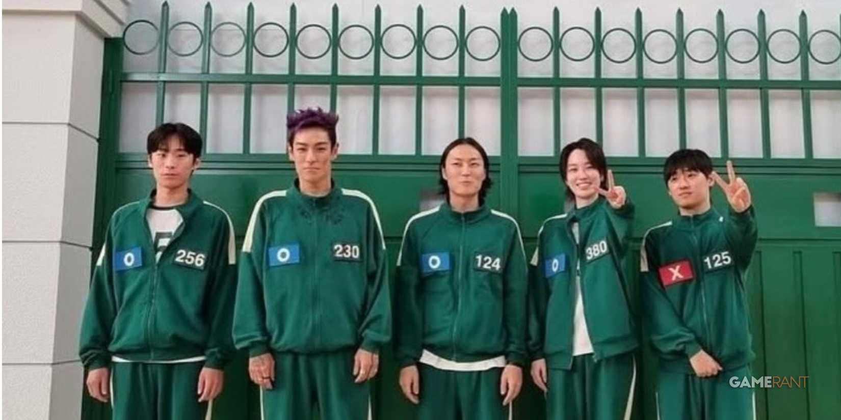 a photo of five smilling players in the squid game series