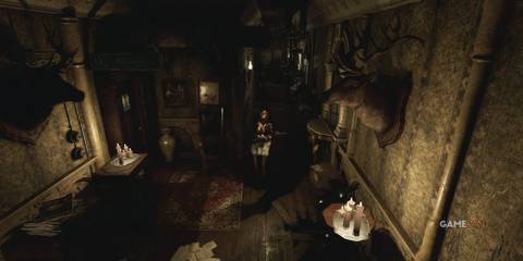 9 Best Modern Retro-Survival Horror Games, Ranked Woman walks through a dark coridor