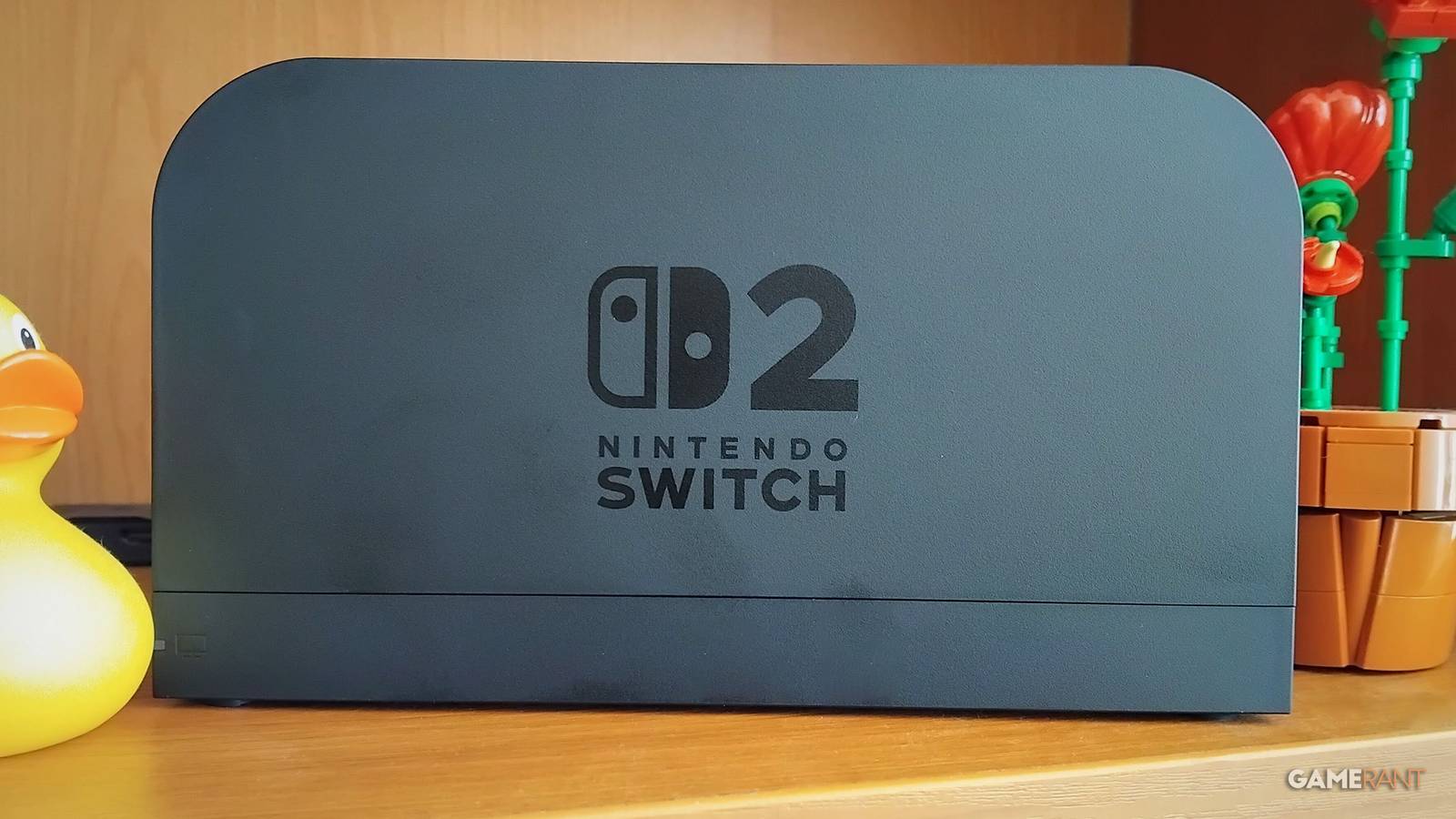 Nintendo Switch 2 dock on shelf next to rubber duck and LEGO plant The Best War Games photo