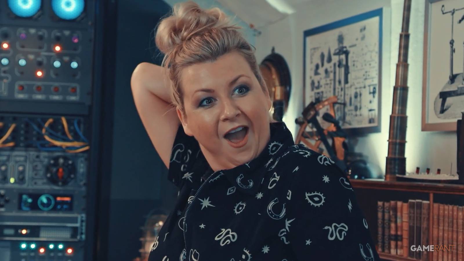 Taskmaster Season 19 Episode 9 S19E09 Rosie Ramsey reaching for envelope on her back