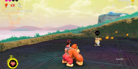 Donkey Kong approaches Cranky Kong near several gold pieces in Donkey Kong Bananza