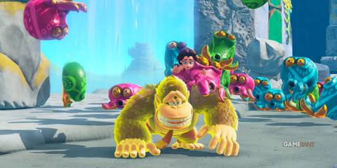 Donkey Kong glows yellow while crawling with Pauline as colorful octopuses chase them