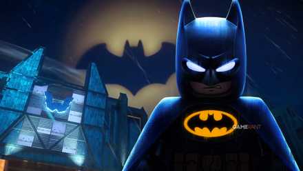 Lego Batman standing in front of the bat signal