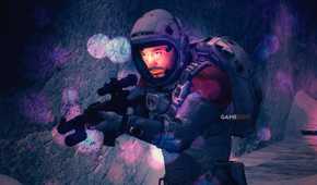 A Starfield character wearing a space suit and holding an assault rifle in a dark cave, with a faint bokeh effect visible in the foreground.